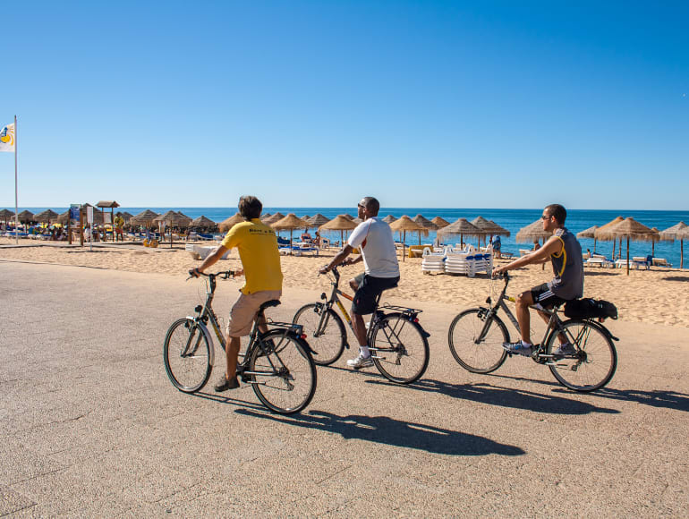 Biking on the side walk next to the beach 
